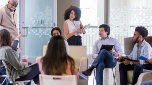 Meeting of seven people in an office with glass windows